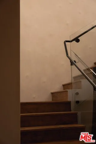 a view of entryway with wooden floor and livingroom view