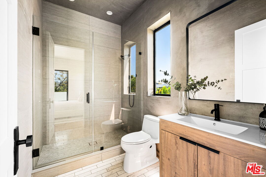 6546 Colgate Avenue Los Angeles, CA 90048 - Photo 28 of 42 a bathroom with a granite countertop sink toilet and shower