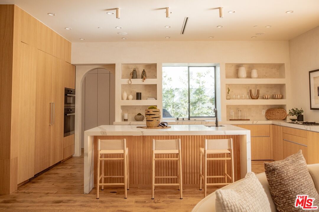 6546 Colgate Avenue Los Angeles, CA 90048 - Photo 6 of 42 a kitchen with stainless steel appliances granite countertop a stove and a refrigerator