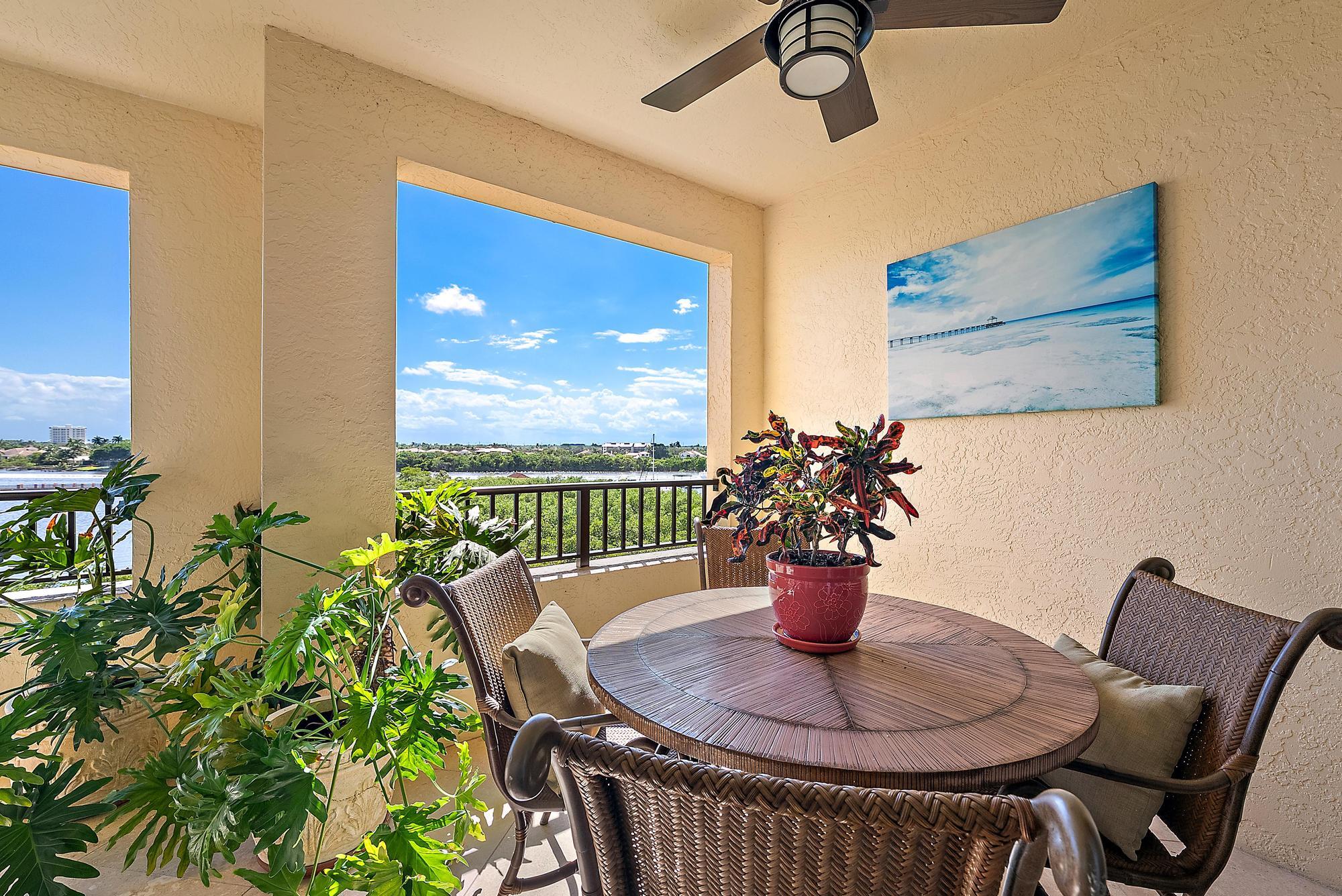 500 Highway 1, Unit 402 Jupiter, FL 33477 - Photo 11 of 37 a dining room with furniture potted plants and wooden floor