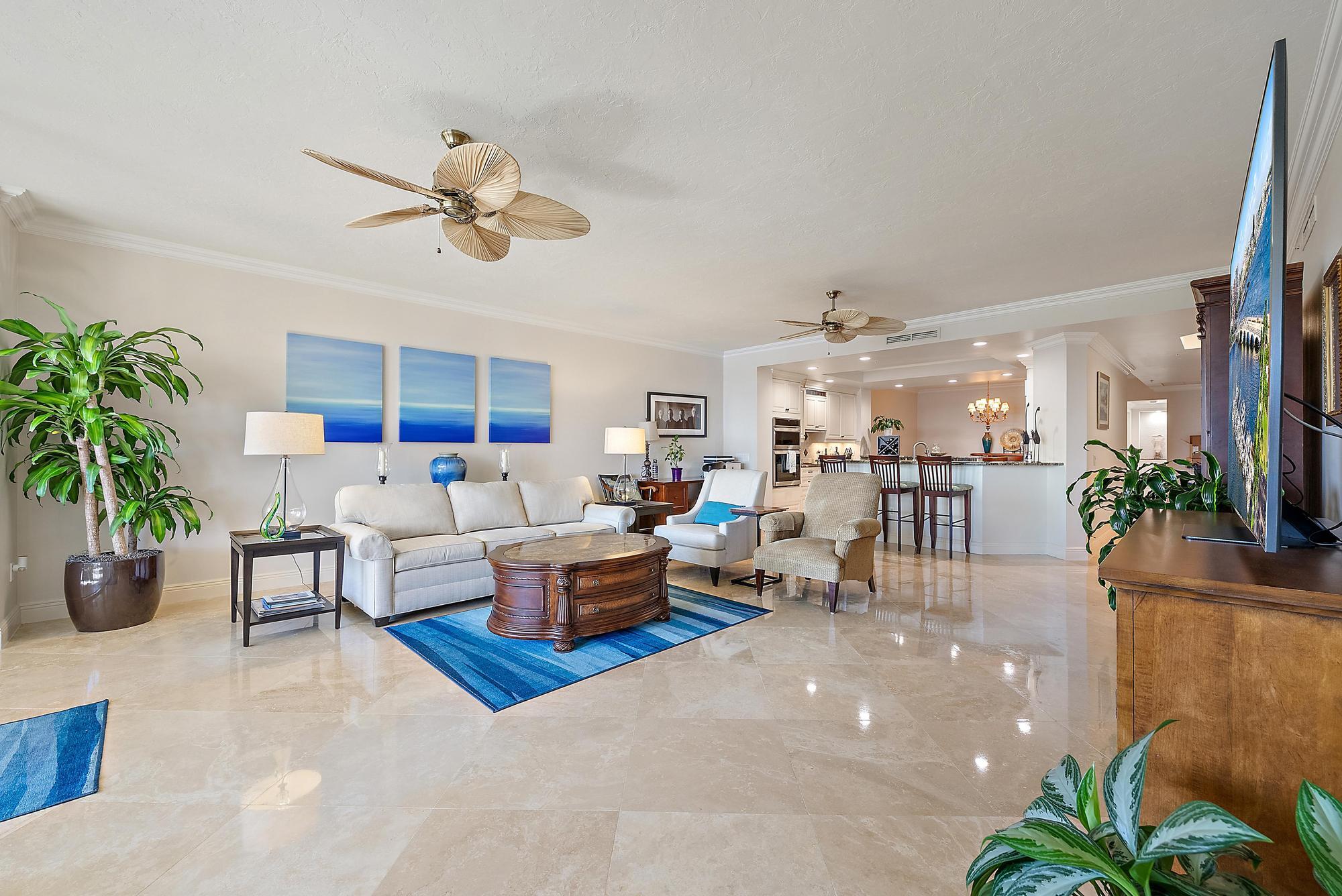 500 Highway 1, Unit 402 Jupiter, FL 33477 - Photo 13 of 37 a living room with furniture kitchen view and a potted plant