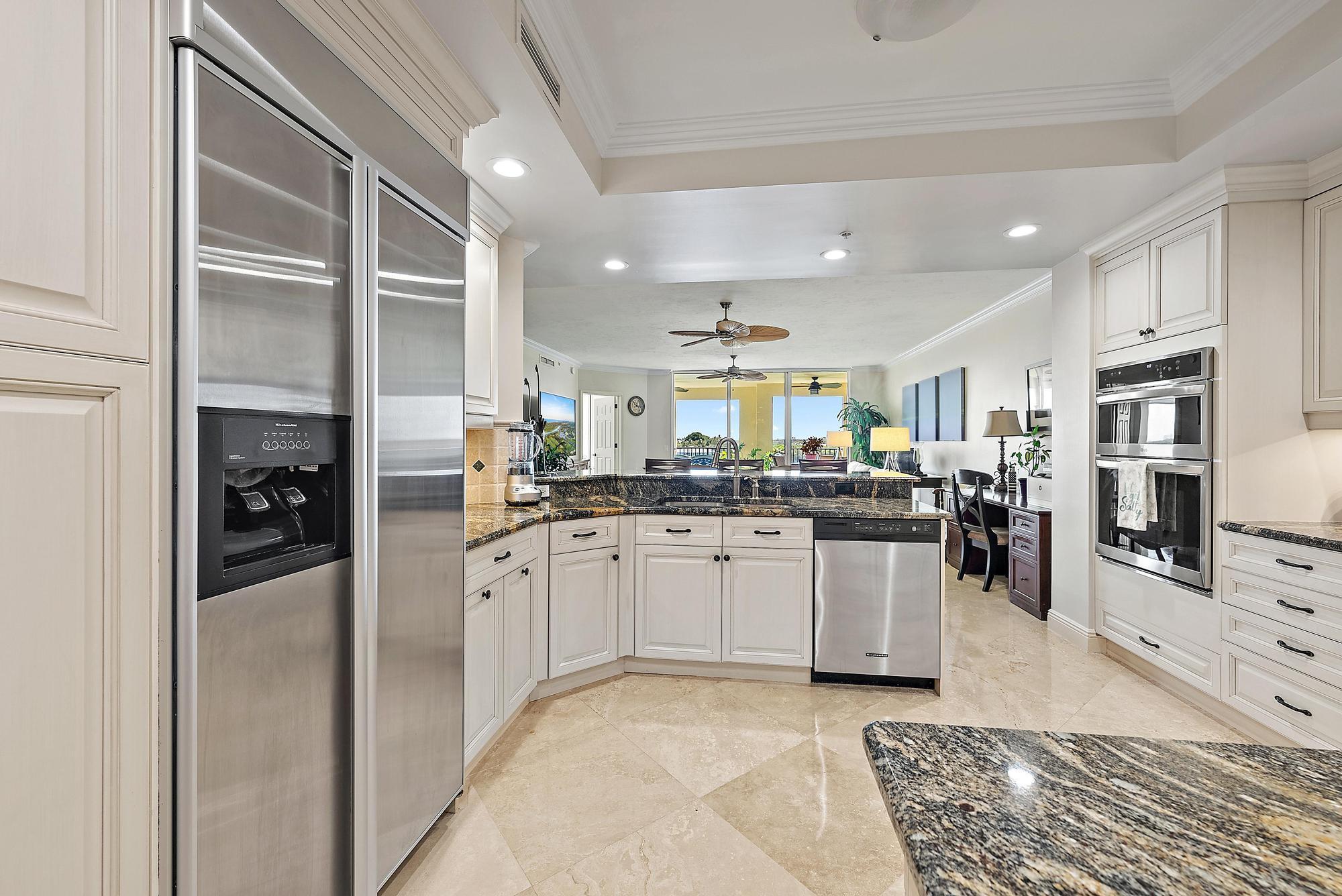 500 Highway 1, Unit 402 Jupiter, FL 33477 - Photo 15 of 37 a kitchen with stainless steel appliances granite countertop a refrigerator and a sink