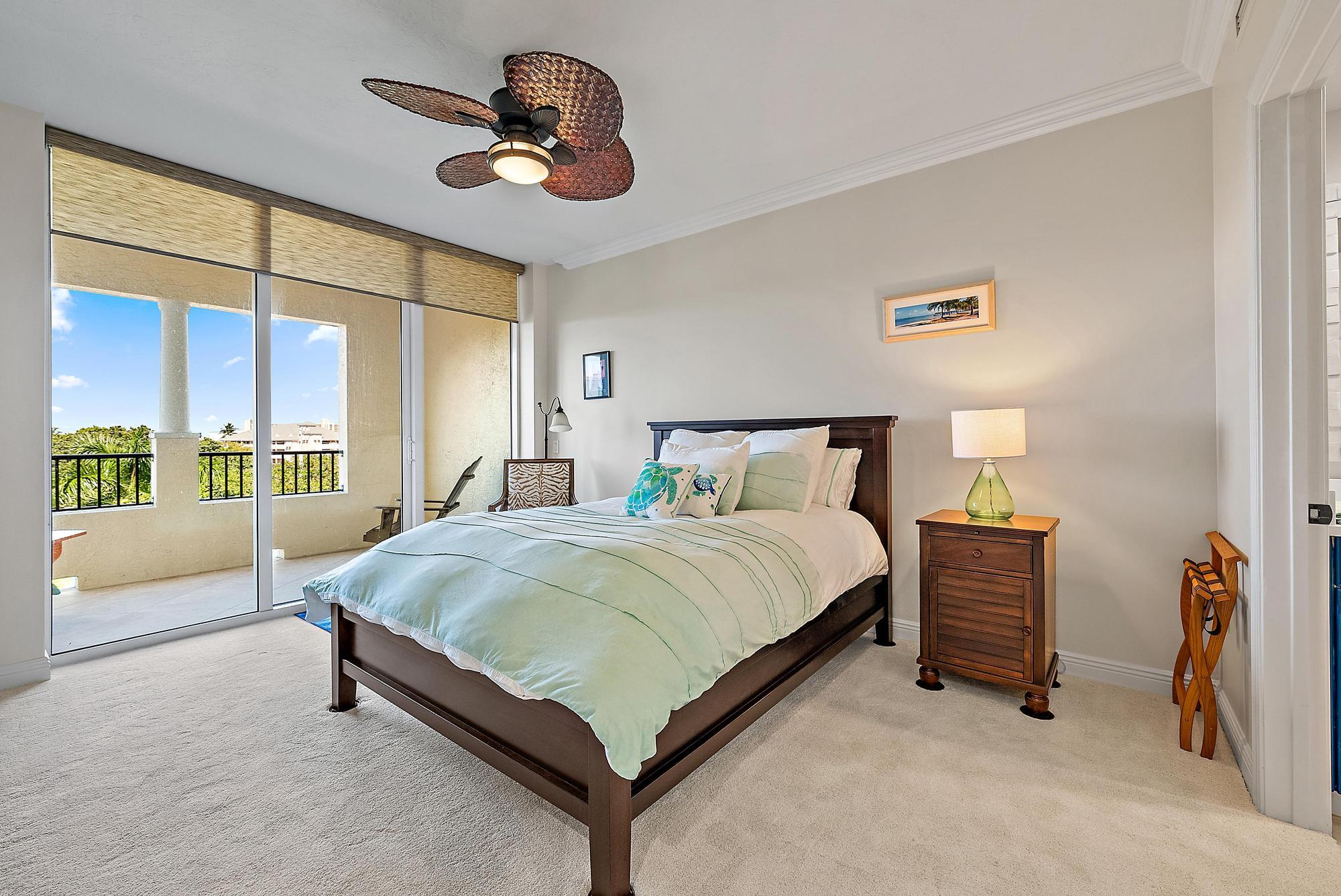 500 Highway 1, Unit 402 Jupiter, FL 33477 - Photo 20 of 37 a bedroom with a bed and a large mirror