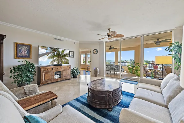 a living room with furniture a rug and a large window