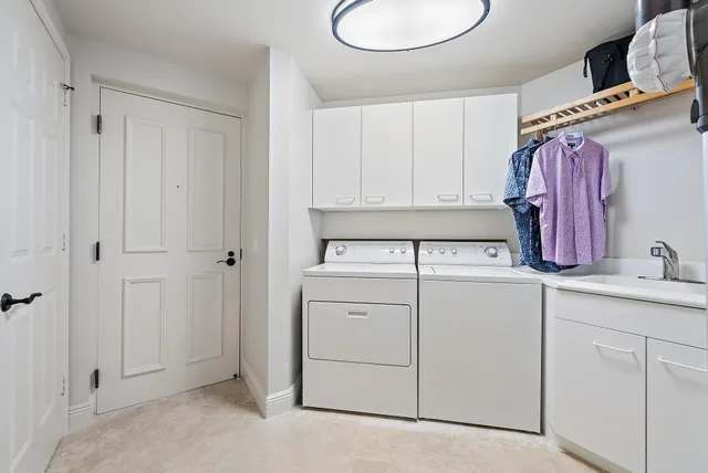 a view of storage and utility room with two washing machine