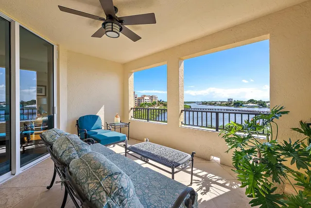 a balcony with furniture and a potted plant