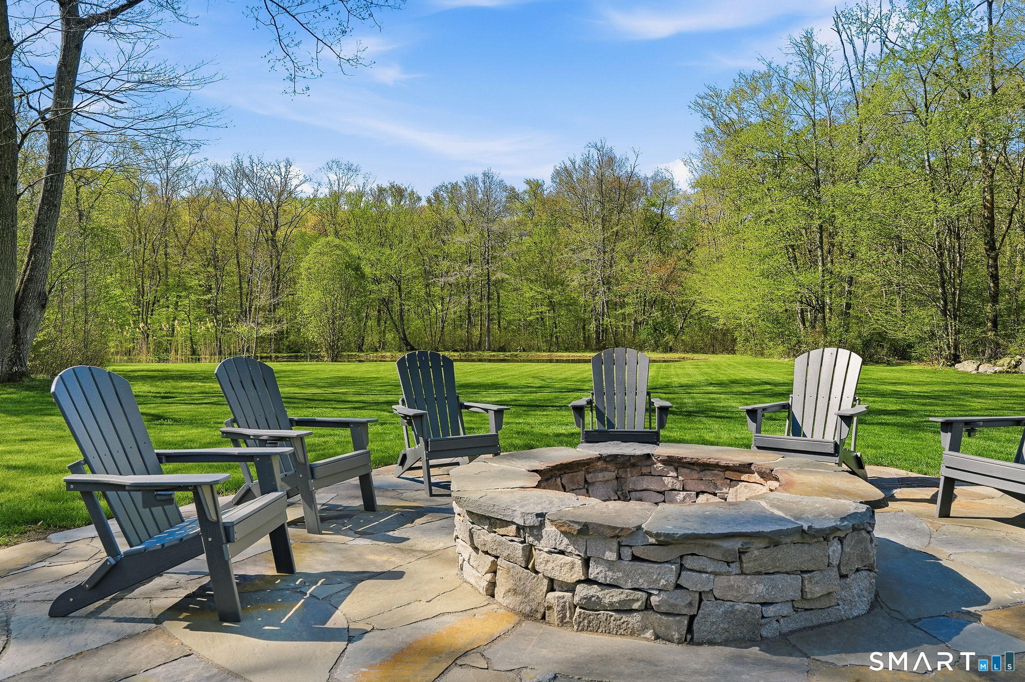 61 Mystic Road North Stonington, CT 06359 - Photo 28 of 40 a view of a chairs and table in the back yard