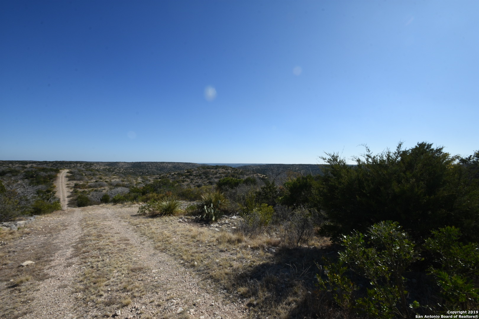 1052 Steep Road Del Rio, TX 78840 - Photo 16 of 25 a view of a dry yard with wooden fence