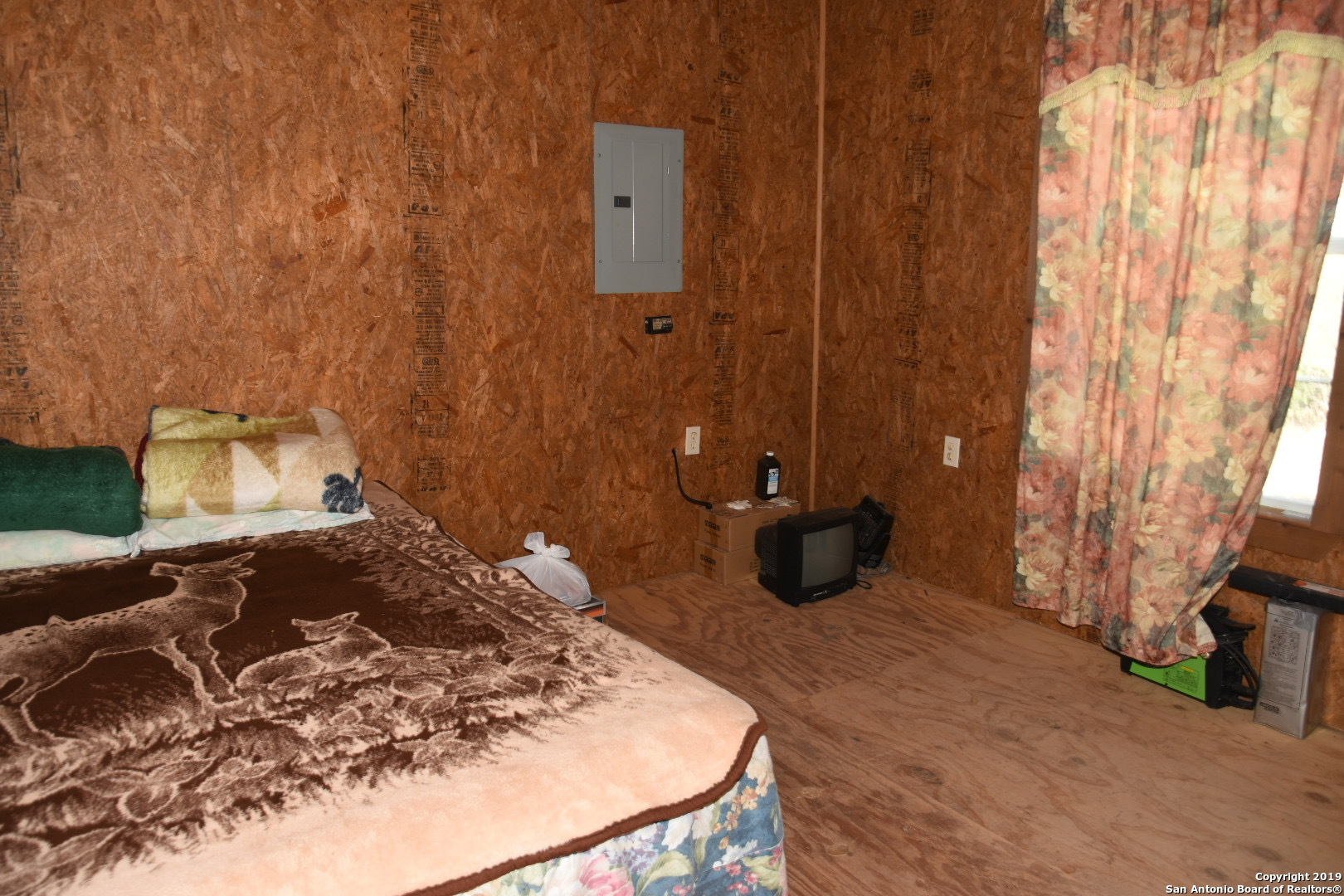 1052 Steep Road Del Rio, TX 78840 - Photo 17 of 25 a bed sitting in a room next to a window
