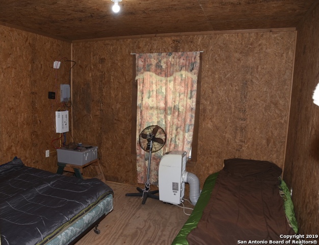 1052 Steep Road Del Rio, TX 78840 - Photo 22 of 25 a bed sitting in a room next to a window