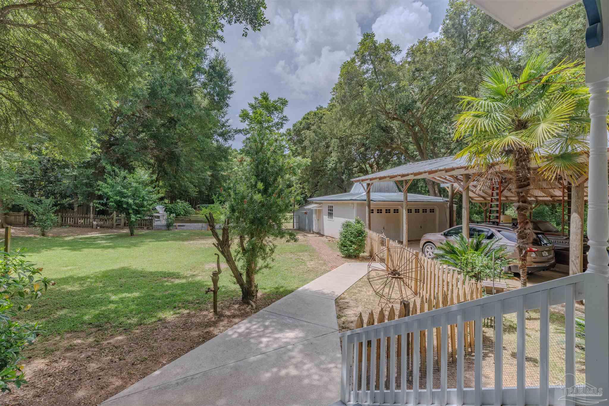 5049 Guernsey Road Pace, FL 32571 - Photo 53 of 61 a view of a house with backyard and garden