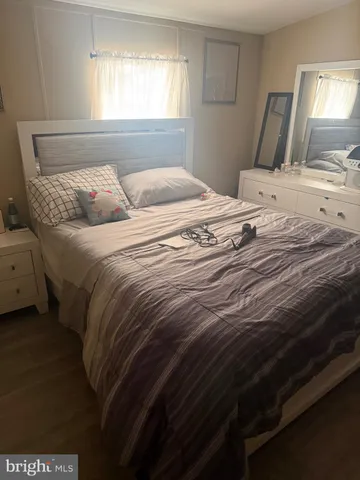 a bedroom with a bed and a mirror