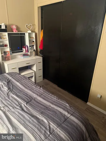 a bedroom with a bed and a potted plant