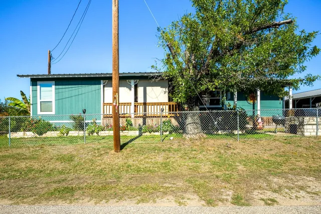a backyard of a house with table and chairs