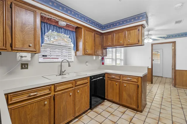 a kitchen with stainless steel appliances granite countertop a sink and cabinets