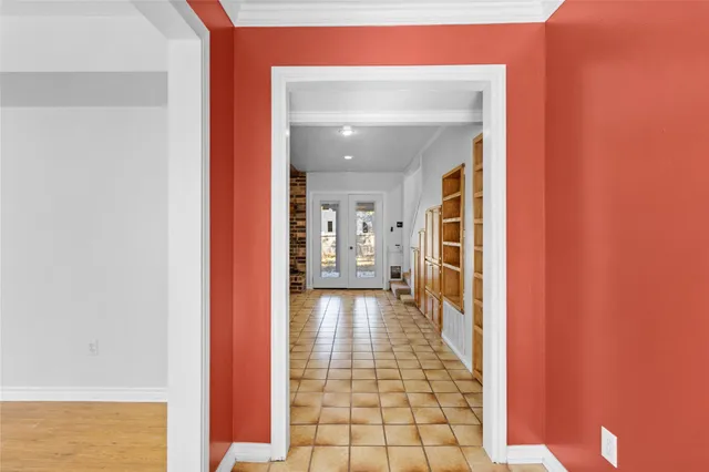 a view of a hallway with wooden floor