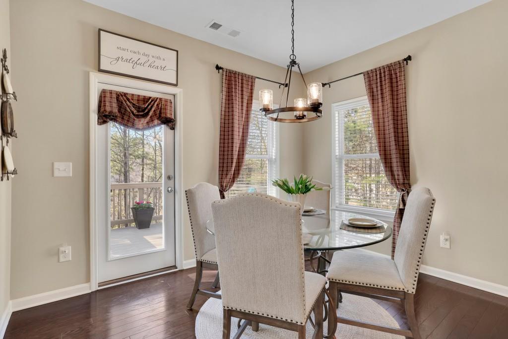 6130 Boulder Gate Way Cumming, GA 30028 - Photo 13 of 38 a view of a dining room with furniture window and wooden floor