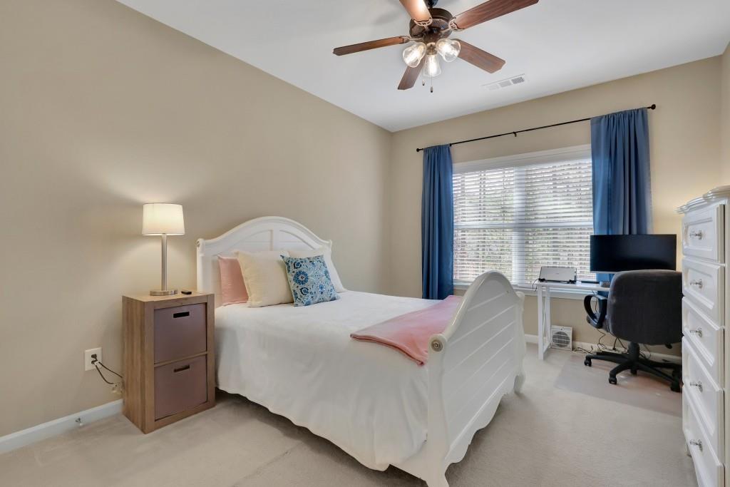 6130 Boulder Gate Way Cumming, GA 30028 - Photo 15 of 38 a bedroom with a bed and chair