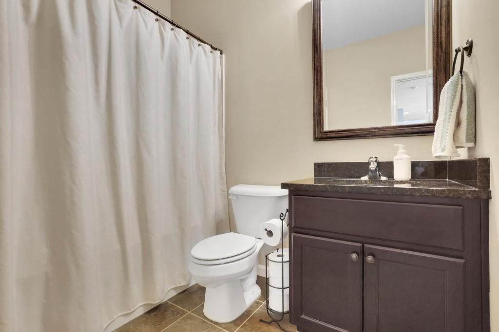 6130 Boulder Gate Way Cumming, GA 30028 - Photo 16 of 38 a bathroom with a granite countertop sink and a toilet