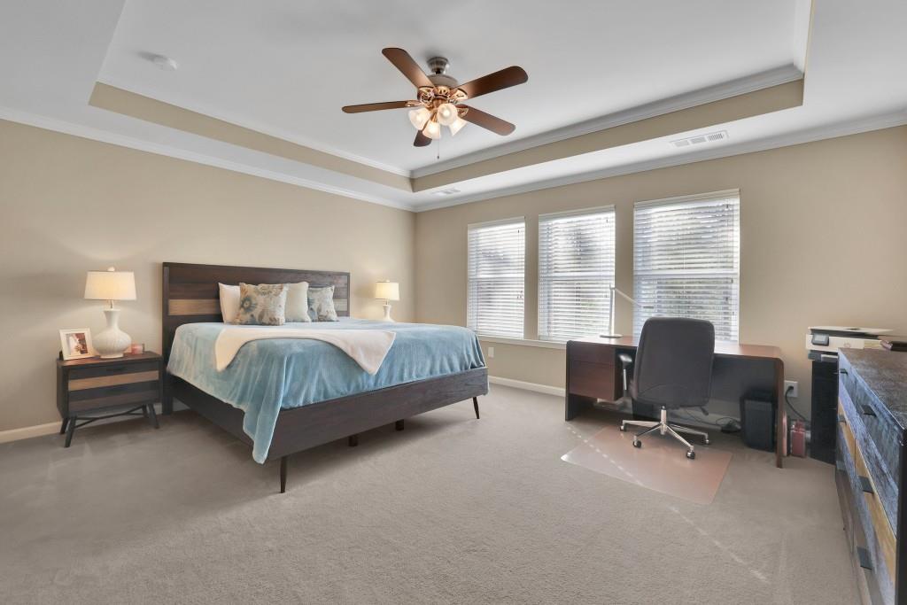 6130 Boulder Gate Way Cumming, GA 30028 - Photo 18 of 38 a bedroom with a bed workspace and a window