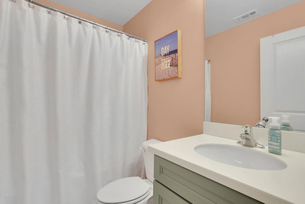 6130 Boulder Gate Way Cumming, GA 30028 - Photo 24 of 38 a bathroom with a sink and toilet