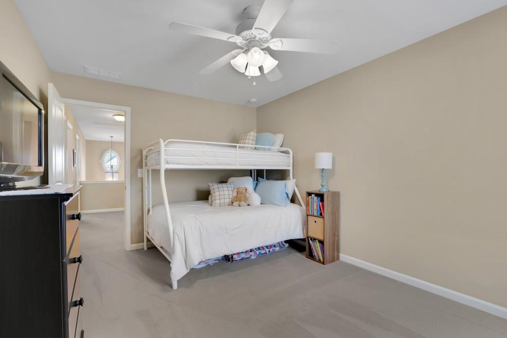 6130 Boulder Gate Way Cumming, GA 30028 - Photo 26 of 38 a bedroom with a bed and a chandelier