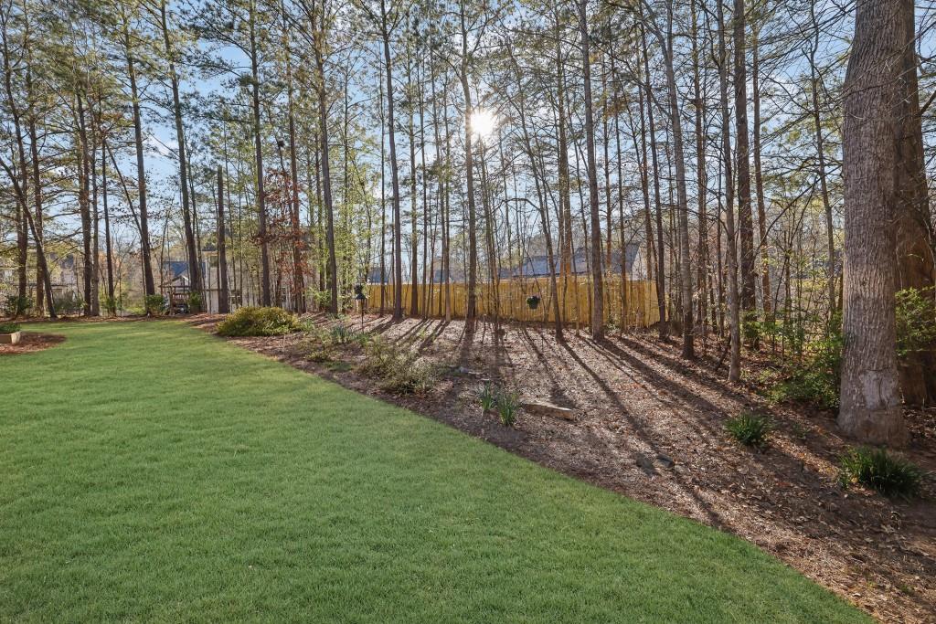 6130 Boulder Gate Way Cumming, GA 30028 - Photo 29 of 38 a view of a backyard with large trees
