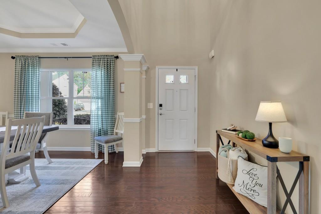 6130 Boulder Gate Way Cumming, GA 30028 - Photo 3 of 38 a view of an entryway with wooden floor and a livingroom