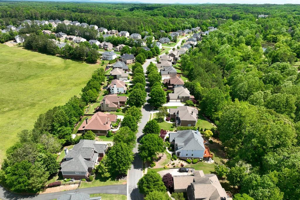 6130 Boulder Gate Way Cumming, GA 30028 - Photo 36 of 38 an aerial view of residential houses with outdoor space and trees all around