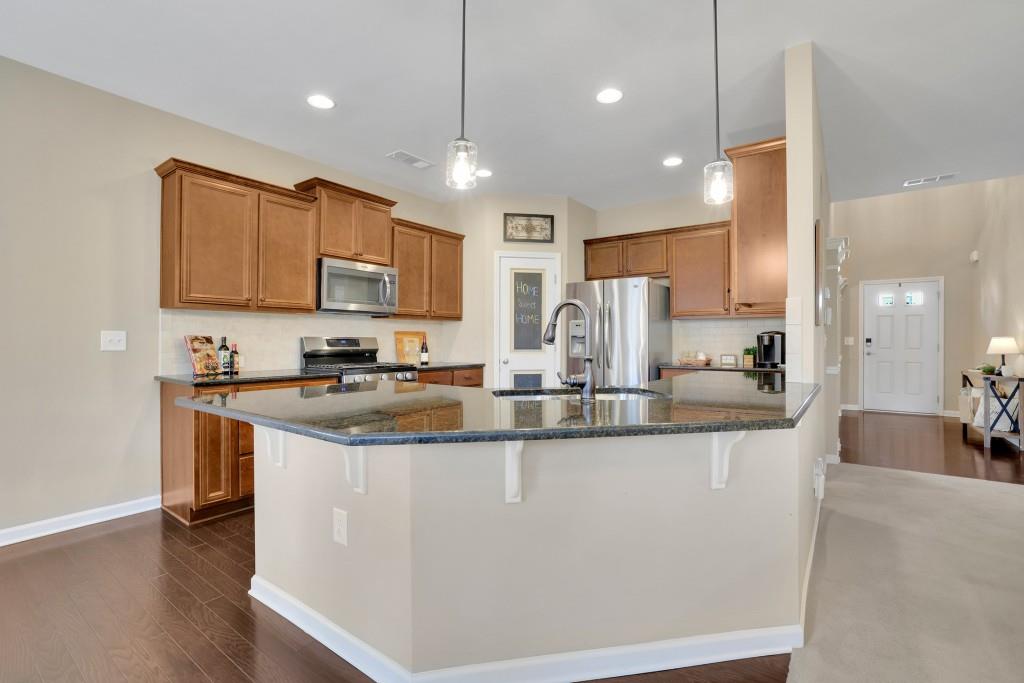 6130 Boulder Gate Way Cumming, GA 30028 - Photo 8 of 38 a kitchen with stainless steel appliances granite countertop a sink a stove and a refrigerator