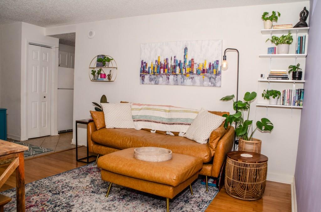 a living room with furniture and wooden floor