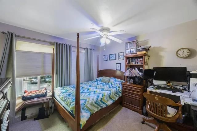 a bedroom with a bed and a tv