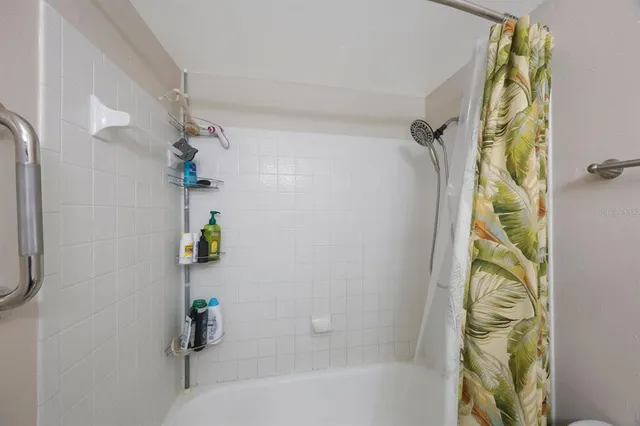 a bathroom with a bathtub and shower