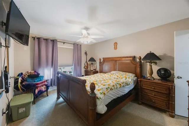 a bedroom with a bed and flat screen tv