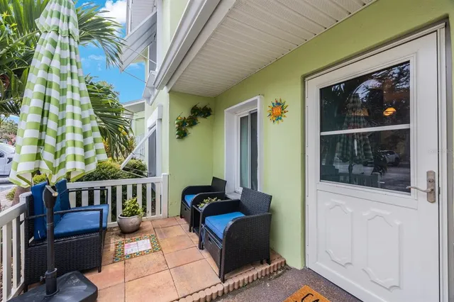 a view of a house with a large window and wooden fence
