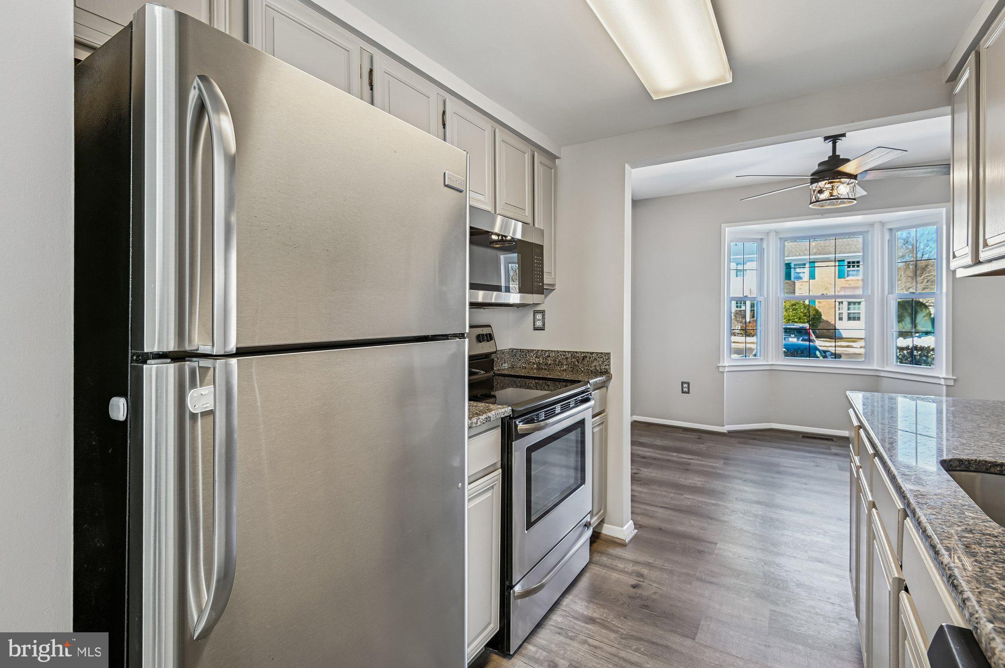 1753 Castleford Square Crofton, MD 21114 - Photo 11 of 30 a kitchen with stainless steel appliances granite countertop a refrigerator and a stove top oven