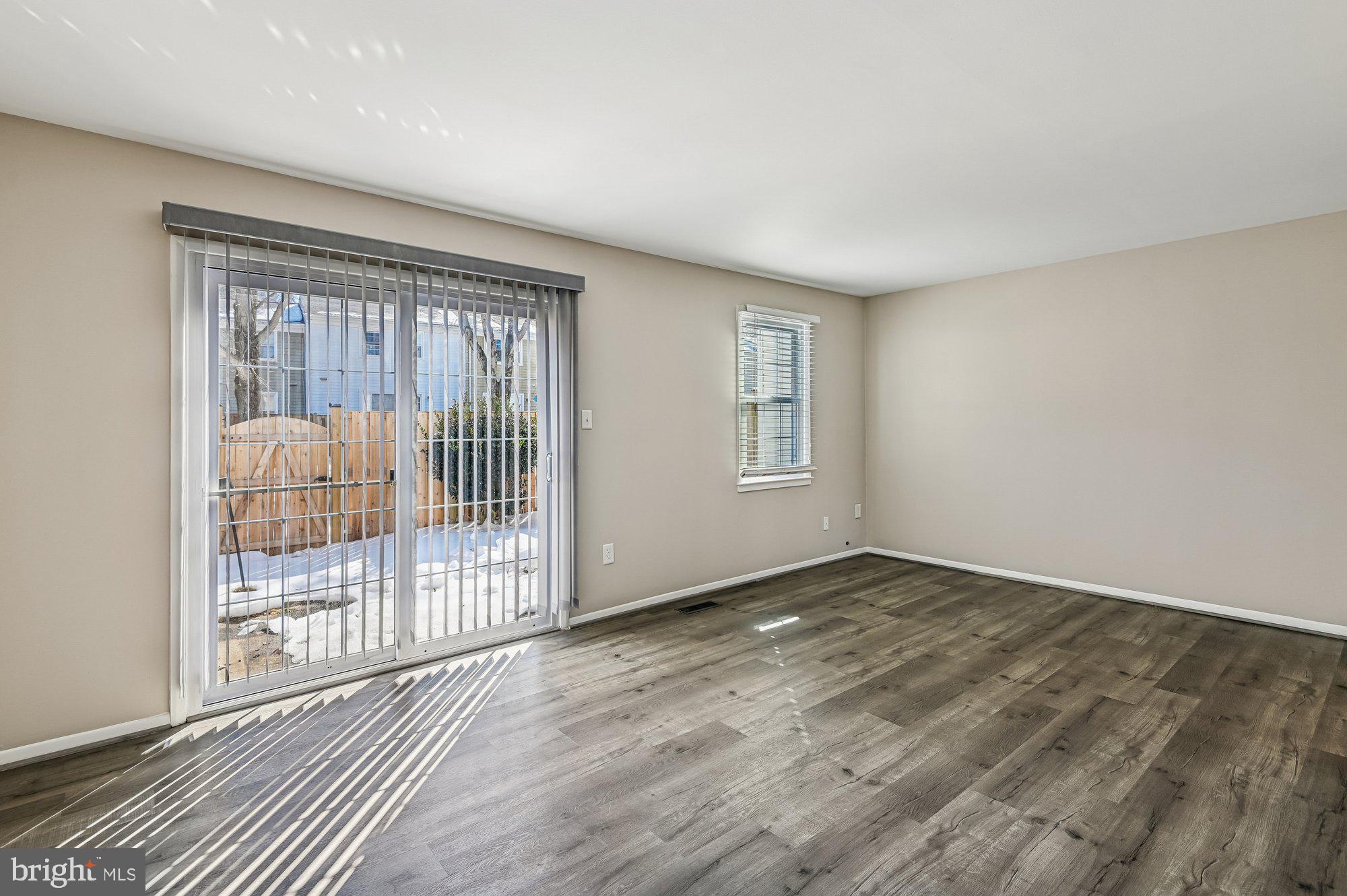 1753 Castleford Square Crofton, MD 21114 - Photo 12 of 30 an empty room with wooden floor and windows