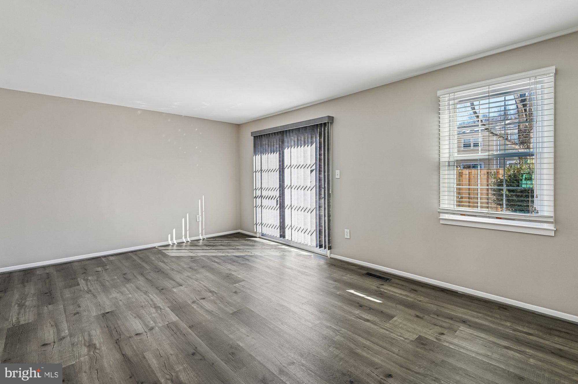 1753 Castleford Square Crofton, MD 21114 - Photo 13 of 30 a view of an empty room with wooden floor and a window