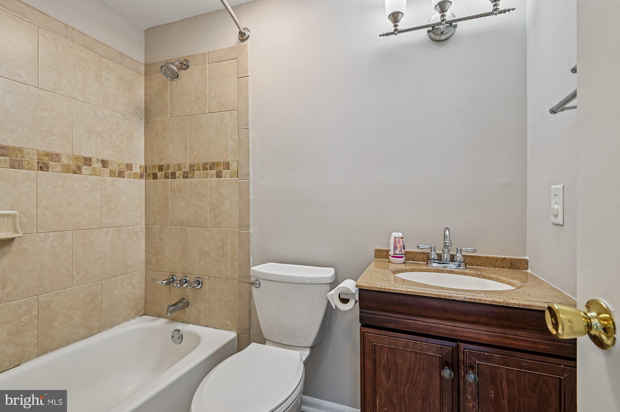1753 Castleford Square Crofton, MD 21114 - Photo 29 of 30 a bathroom with a sink a toilet and shower