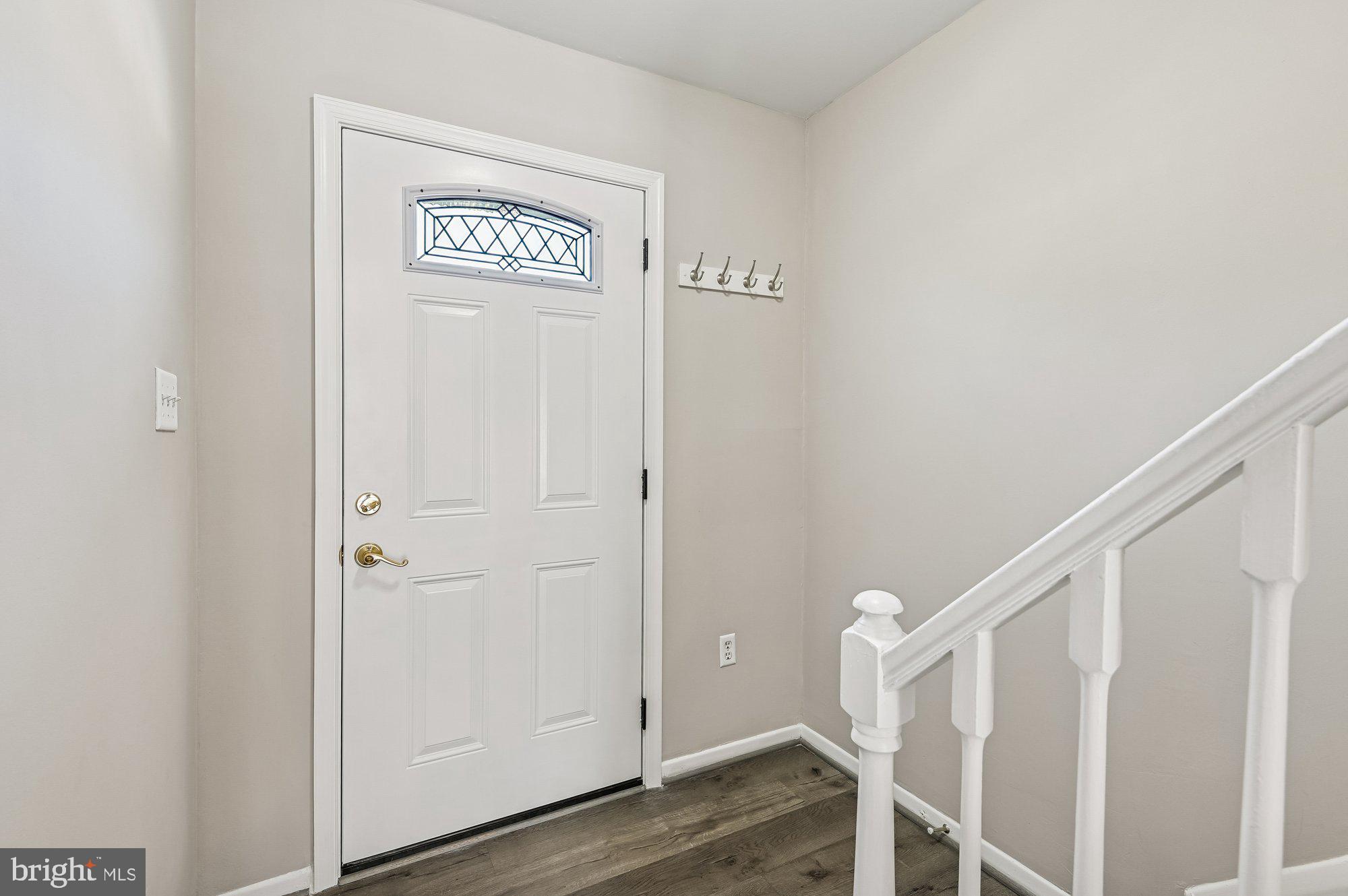 1753 Castleford Square Crofton, MD 21114 - Photo 4 of 30 a view of a hallway with wooden floor