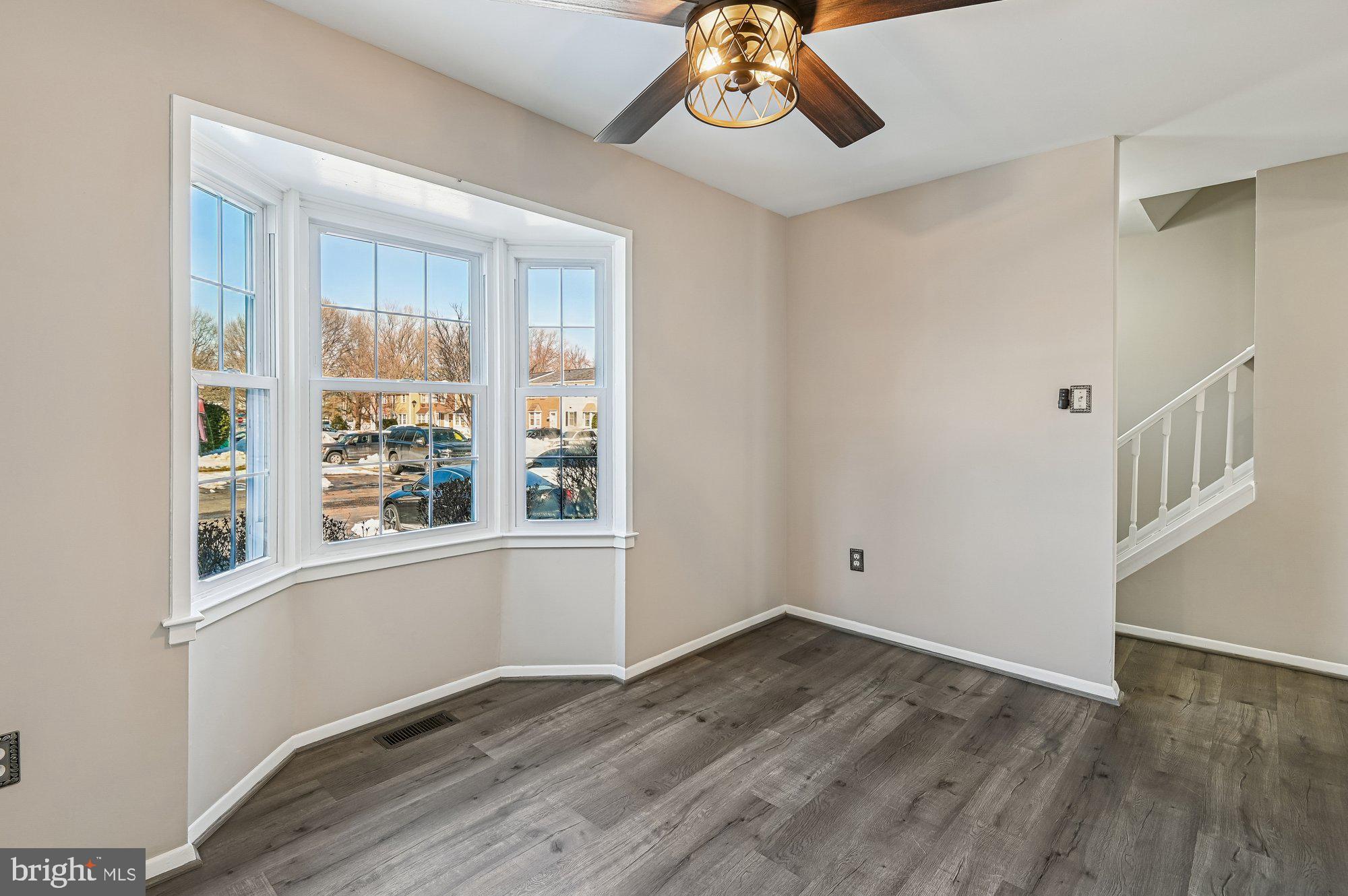 1753 Castleford Square Crofton, MD 21114 - Photo 5 of 30 a view of an empty room with wooden floor and a window