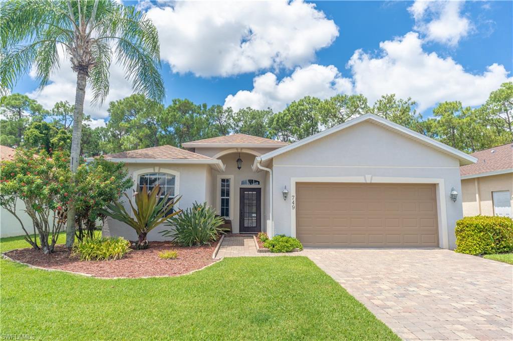 749 Crossfield Circle Naples, FL 34104 - Photo 1 of 37 a front view of house with yard and green space