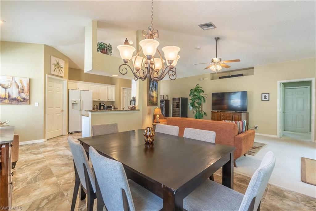 749 Crossfield Circle Naples, FL 34104 - Photo 12 of 37 a view of a dining room with furniture and wooden floor