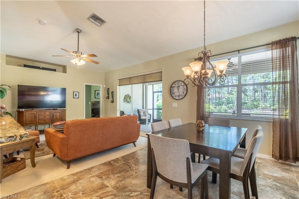 749 Crossfield Circle Naples, FL 34104 - Photo 13 of 37 a living room with furniture a chandelier and a window