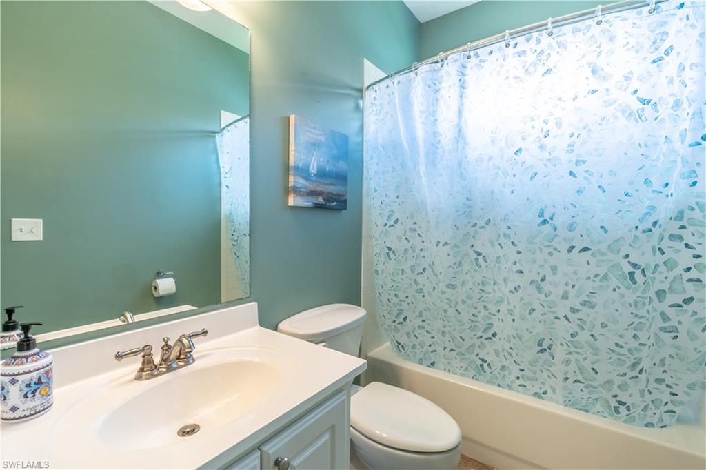 749 Crossfield Circle Naples, FL 34104 - Photo 21 of 37 a bathroom with a sink a toilet and shower curtain