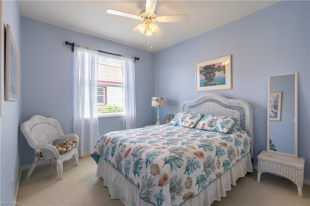 749 Crossfield Circle Naples, FL 34104 - Photo 22 of 37 a bedroom with a bed and a chandelier