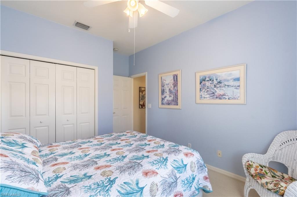 749 Crossfield Circle Naples, FL 34104 - Photo 23 of 37 a bedroom with a bed and a chandelier