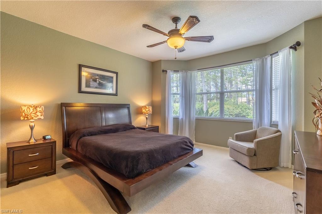 749 Crossfield Circle Naples, FL 34104 - Photo 24 of 37 a bedroom with a bed and a couch