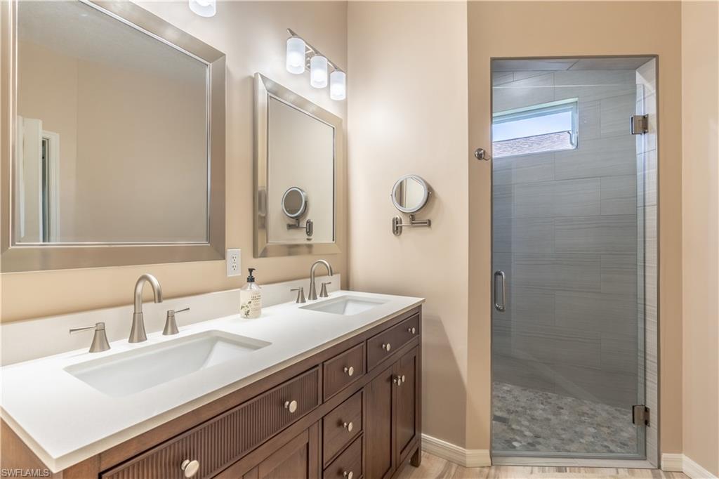 749 Crossfield Circle Naples, FL 34104 - Photo 26 of 37 a bathroom with a sink and a mirror