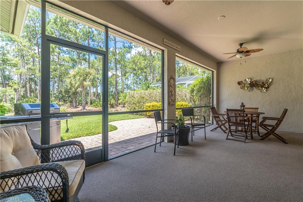 749 Crossfield Circle Naples, FL 34104 - Photo 28 of 37 a living room with furniture and floor to ceiling windows